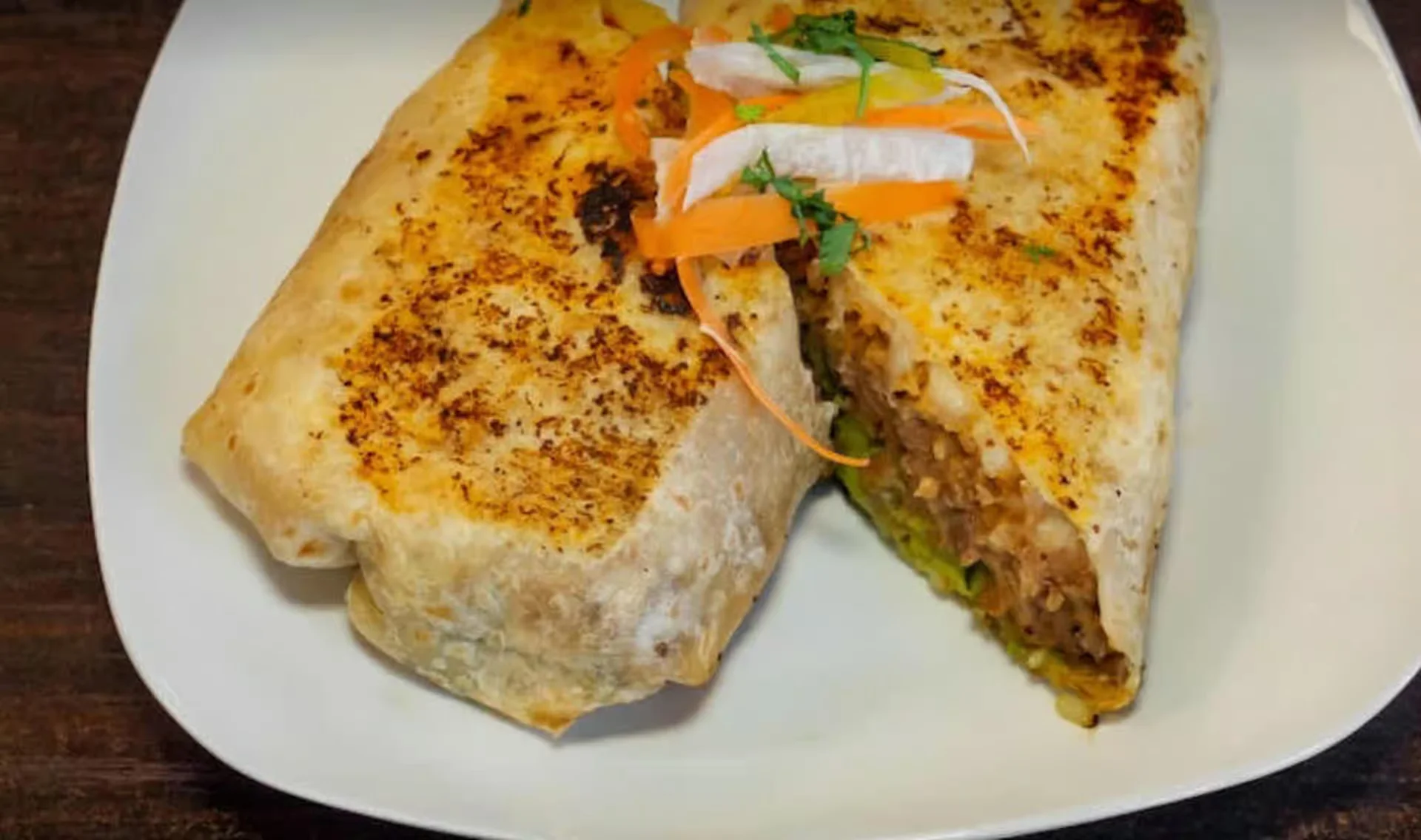 Super Burrito - A massive burrito packed with your choice of meat, rice, beans, cheese, sour cream, and guacamole.